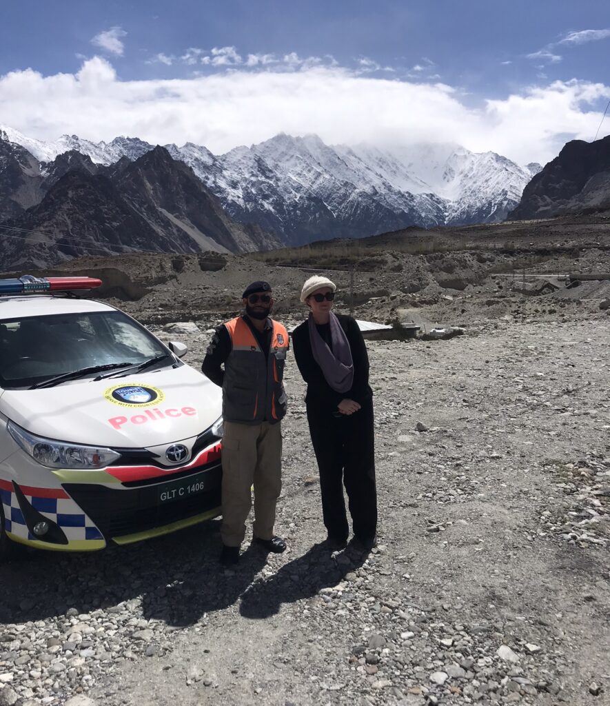 A Pakistani police officer and foreign visitor in Gilgit-Baltistan
